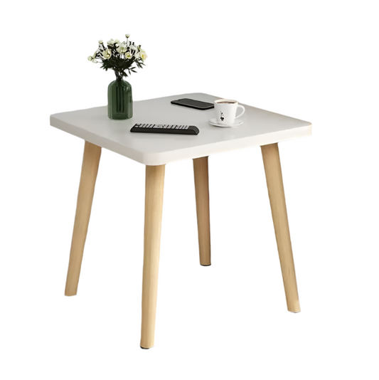A small square side table with a white tabletop and wooden legs, displaying a potted plant and a coffee cup on top.