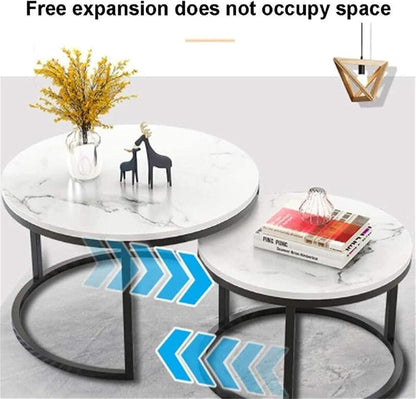 Round marble coffee table with decorative items on a light gray background
